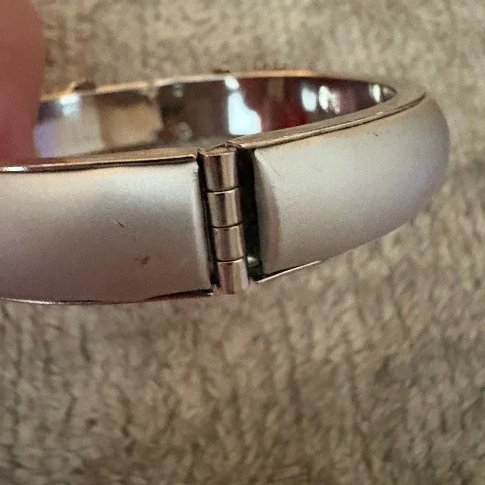 GUC silver tone bangle with safety chain